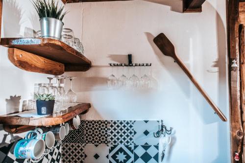a bathroom with a black and white tile floor and shelves at Koliba Šume Pjevaju - robinzonski smjestaj, struja 12 V, voda iz cisterne in Mrkopalj