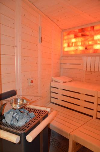 a sauna with a grill and a bench in it at Landhotel Spessartruh in Frammersbach