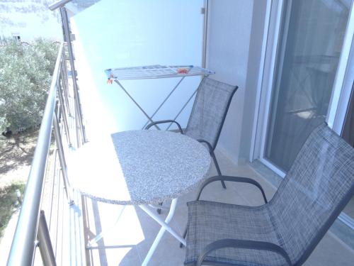 two chairs and a table on a balcony at Vergina Pension in Sarti