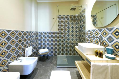 a bathroom with a sink and a toilet and a mirror at GREEN RIBBON in Milan