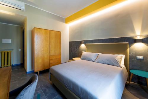 a hotel room with a bed and a chair at GREEN RIBBON in Milan