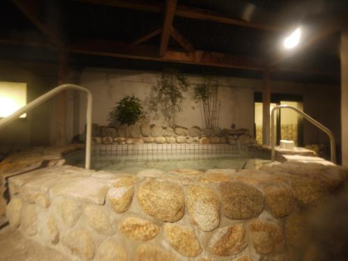 a large bed of bread in a room at Route Inn Grantia Fukuyama Spa Resort in Fukuyama