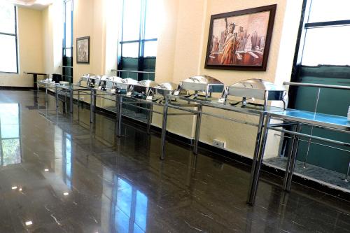 a row of sinks in a room with mirrors at Le Roi Digha in Digha
