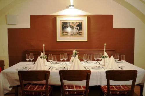a table with a white table cloth and candles on it at Hotel Gasthof Posthalter in Zwiesel