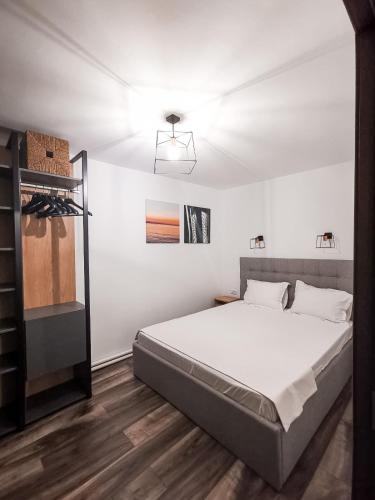 a white bedroom with a bed and a ceiling at Old Town Constanta in Constanţa