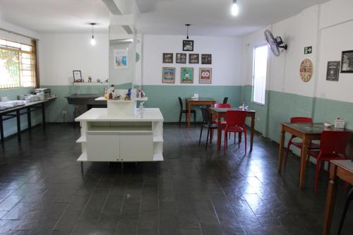 una sala con mesas y sillas en un restaurante en Hotel Galli, en Campo Grande
