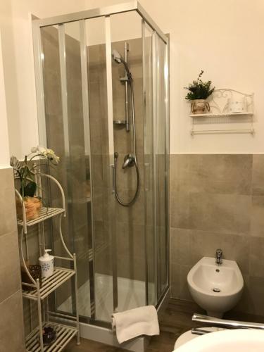 a bathroom with a shower and a toilet and a sink at Piazza Signoria Suite in Florence