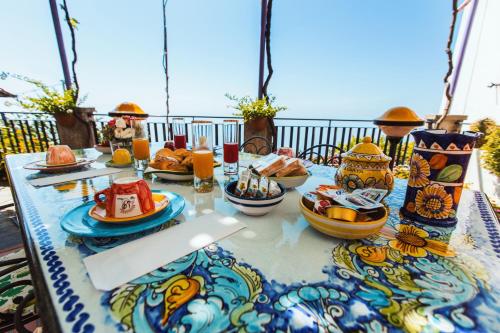 a table with plates of food on top of it at Roccia Fiorita in Furore