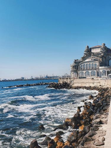 a large building on the shore of the ocean at Old Town Constanta in Constanţa