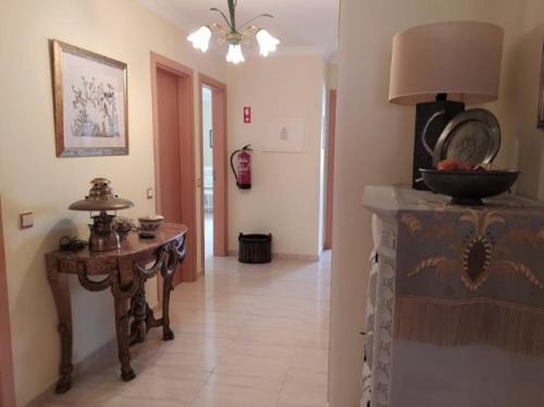 a living room with a table and a fireplace at Beija Flor in Monte Gordo