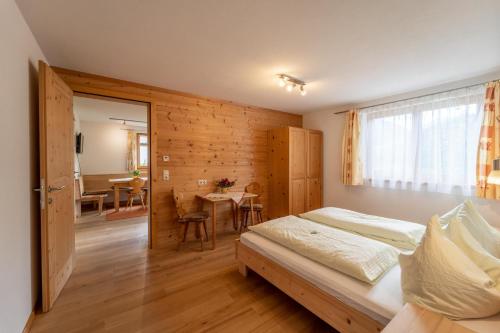 a bedroom with a bed and a dining room at Forsthaus Schoppernau in Schoppernau