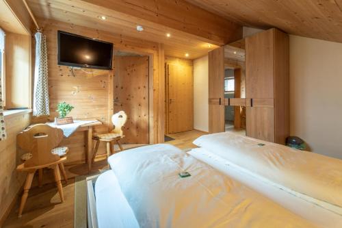 a bedroom with a bed and a desk in a room at Forsthaus Schoppernau in Schoppernau