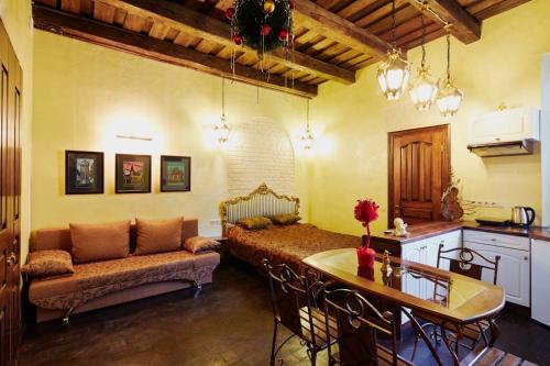 a living room with a couch and a table at Квартира подобово на Площі Ринок 39 in Lviv