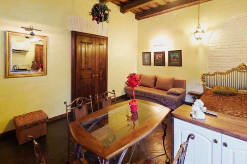 a living room with a table and a couch at Квартира подобово на Площі Ринок 39 in Lviv