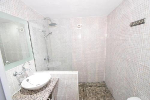 a white bathroom with a sink and a shower at Espuna Walks Casa Los Arcos in Totana