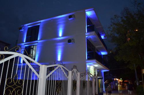 a house with blue lights on the side of it at White Hotel in K'obulet'i