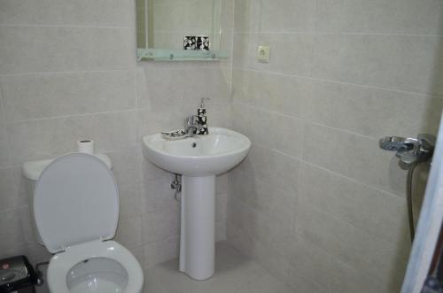 a bathroom with a toilet and a sink at White Hotel in K'obulet'i