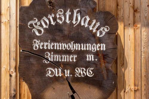 a sign on the side of a wooden wall at Forsthaus Schoppernau in Schoppernau