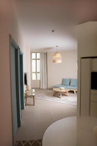a living room with a blue couch and a table at Redcon Suites in Hurghada