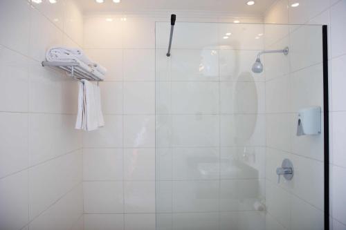 a bathroom with a shower with a glass door at Redcon Suites in Hurghada