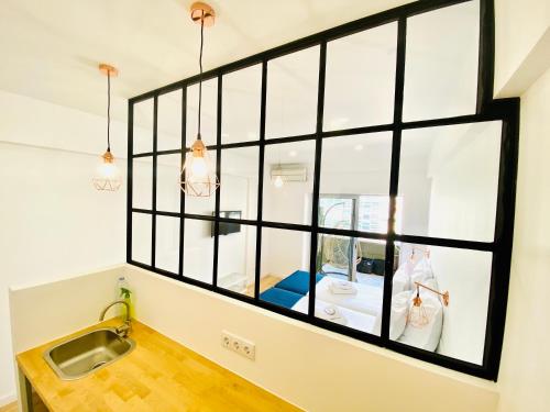 a large window in a kitchen with a sink at The Postcard Avenue in Lisbon