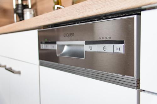 a microwave oven sitting on top of a kitchen counter at Ferienwohnung Alpaka Blick in Schneppenbach