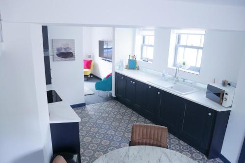 a kitchen with a sink and a counter top at New street Luxury town house in the centre of Holt with free PARKING for one car in Holt