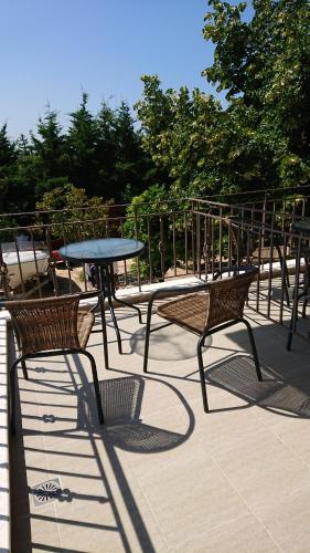 a table and two chairs and a table and a table at Stone house with seaview in Nea Potidaea