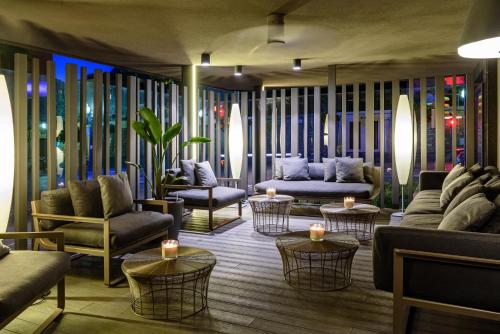 a living room with couches and chairs and tables at Astari in Tarragona