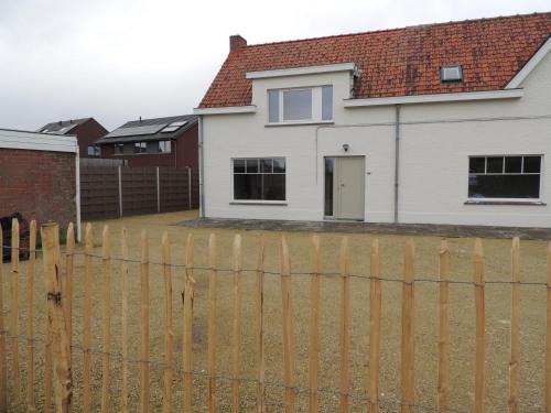 a house with a fence in front of it at "De VRIJBOS ROUTE" alleenstaande dubbele woning! in Kortemark