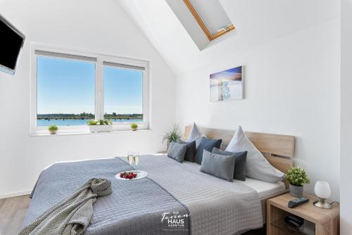 a bedroom with a bed with a bowl of fruit on it at Port 55 in Olpenitz