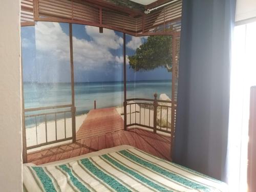 a bedroom with a view of the beach at Hostal Sant Jordi in Tossa de Mar