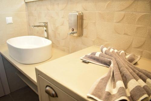 a bathroom with a sink and a counter with a towel at Pasithea in Frangokastello