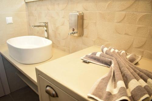 a bathroom with a sink and a counter with a towel at Pasithea villas in Frangokastello