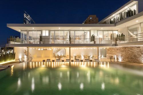 a house with a swimming pool at night at Hotel Boutique Casa Lulu in Mazatlán