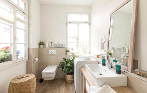 a white bathroom with a sink and a mirror at WÄLDER: Quartier St.Blasien in St. Blasien