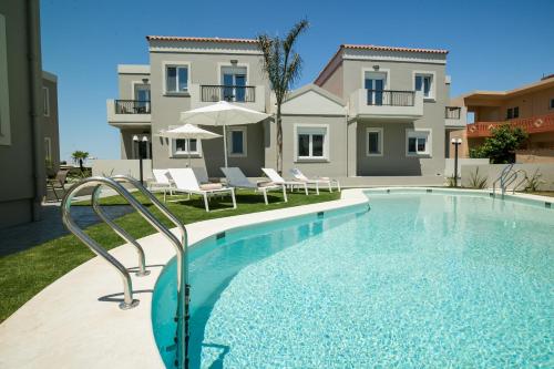 a swimming pool in front of a house at Limosa Luxury Residences in Kissamos