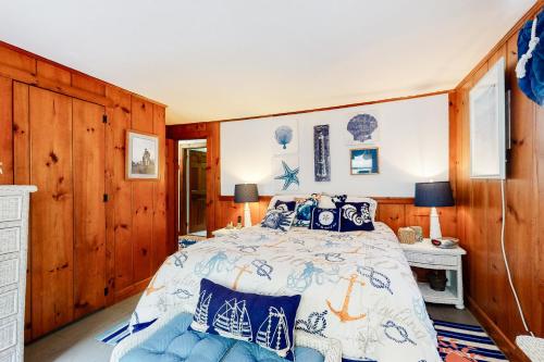 a bedroom with a bed with a blue and white comforter at Paradise by Ocean Edge in Brewster