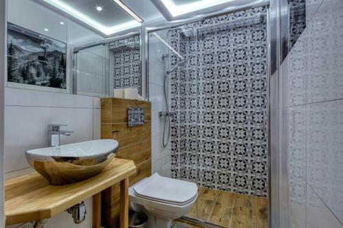 uma casa de banho com um lavatório, um WC e um chuveiro em Pokoje Gościnne Dawidek em Zakopane