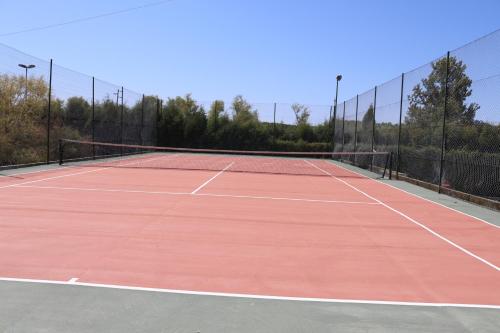 a tennis court with a tennis racket on it at Curia Clube in Curia