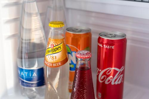 a refrigerator filled with cocacola drinks and soda cans at Hotel Ristorante Maga Circe in San Felice Circeo