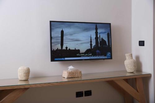 a flat screen tv hanging on a wall at Redcon Suites in Hurghada