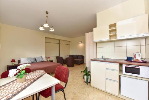 a kitchen and living room with a bed and a couch at "Trakaitis" apartments in Villa in Trakai