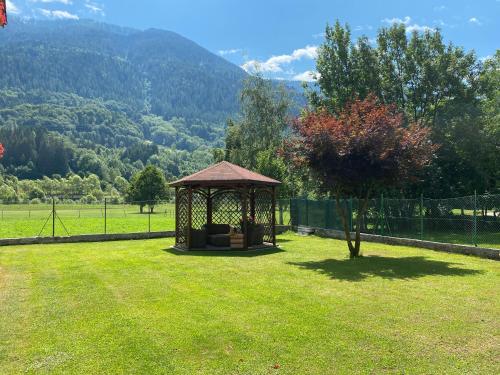 a gazebo in the middle of a grass field at Villa Golf in Pinzolo