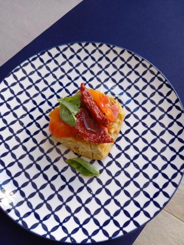 a black and white plate with a piece of food at B&B villa brezza marina in Sant'Isidoro