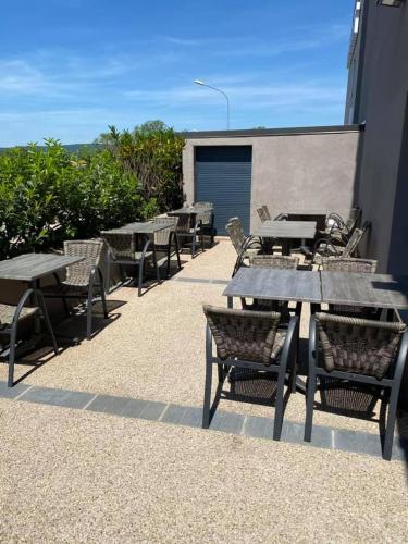 a group of tables and chairs on a patio at Hotel Restaurant Vesontio in Besançon