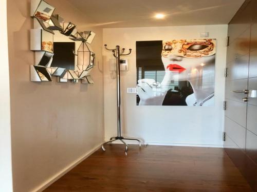 a room with a picture of a woman with a mask on the wall at Luxury botafoch in Ibiza Town