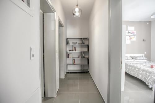 a hallway leading to a bedroom with a bed at Terra di Meteora Suites #1 in Kalabaka