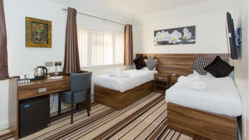 Ένα ή περισσότερα κρεβάτια σε δωμάτιο στο Langley Guest House