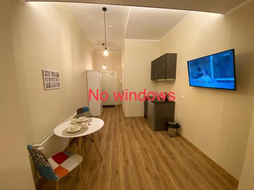 a room with a table and a tv on a wall at Kastanimaja Apartments in Tartu
